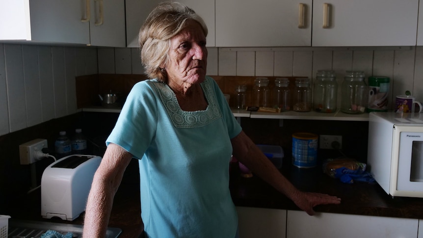 Janice Williams is standing in her kitchen looking pensive.