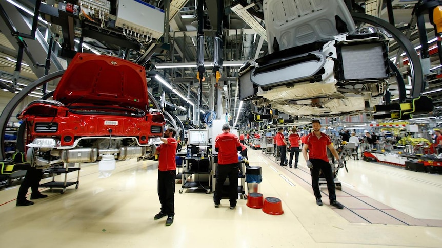 Employees of German car manufacturer Porsche assemble sports  in Germany,