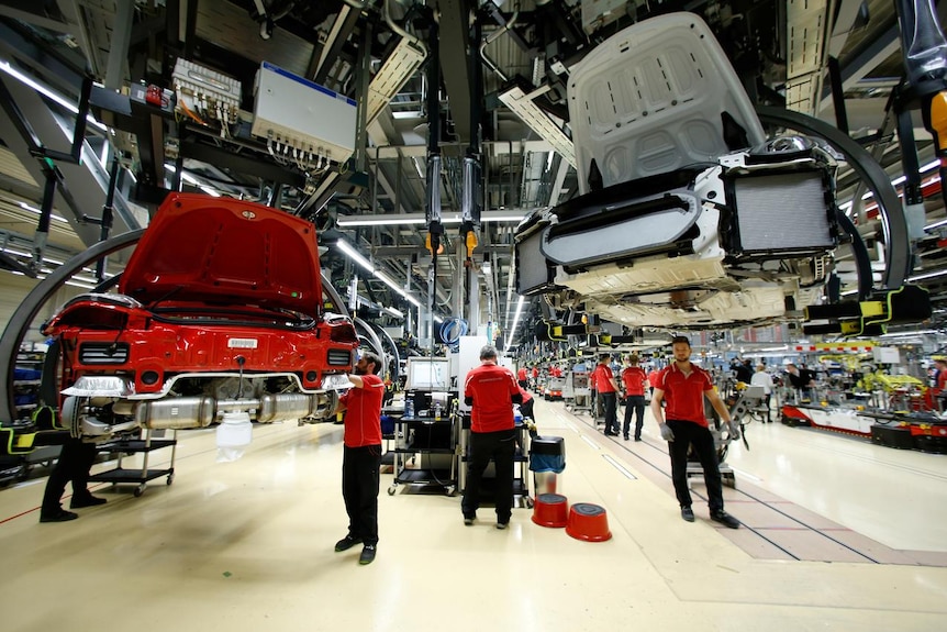 Employees of German car manufacturer Porsche assemble sports  in Germany,