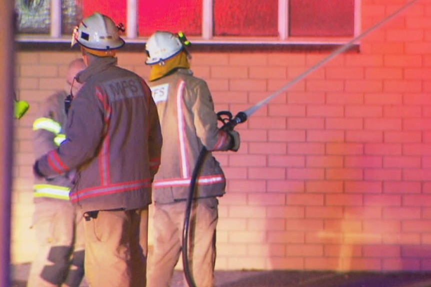 Firefighters at Gepps Cross in glow of the blaze.