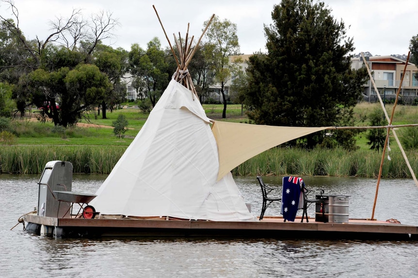 A teepee is set up on a floating platform on Lake Ginninderra