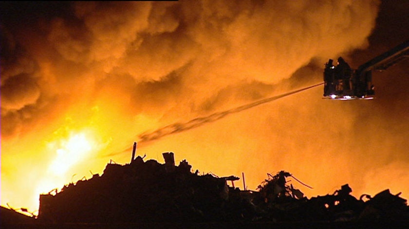 Firefighters battle a metal scrap fire.