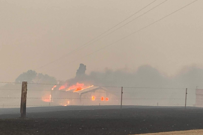 Burning shed in a smoky landscape