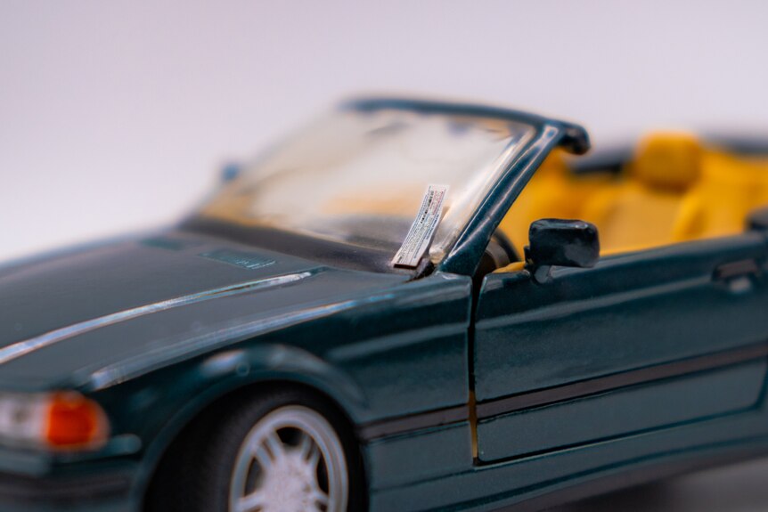 A photo of a miniature fine on a miniature car.