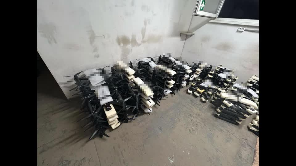 A picture of blurred out drone on a concrete floor. 