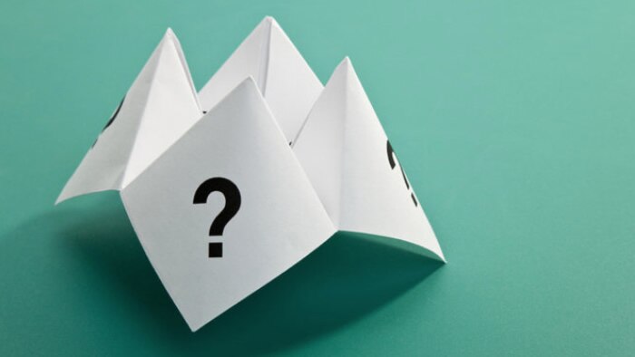 A paper fortune teller with a question mark on one face