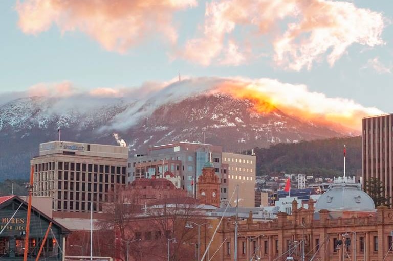 A snow-capped kunanyi/Mount Wellington rises behind Hobart's waterfront.