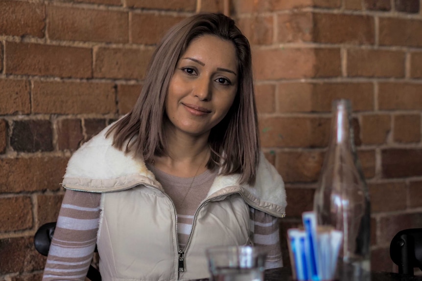 A refugee woman sitting at a table