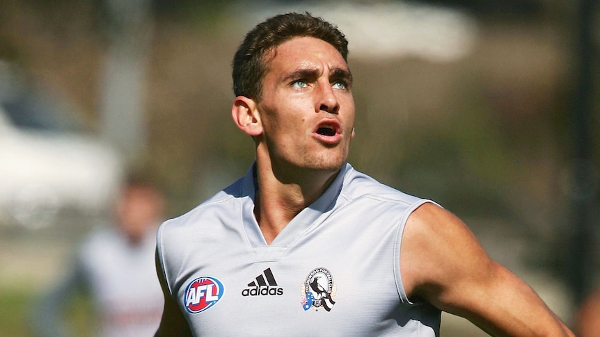 A young man in an AFL jersey.