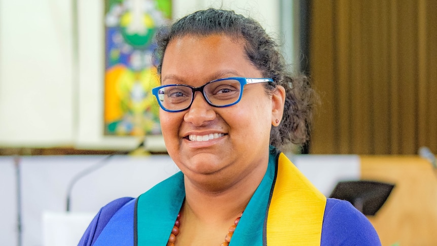 Reverend Radhika Sukumar-White smiles at the camera