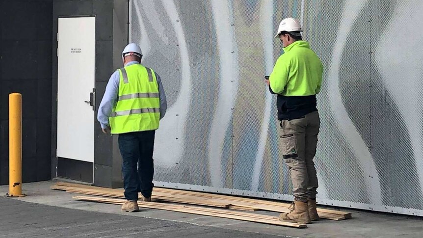 Hobart Myer boards on the ground with worker, January 2019.