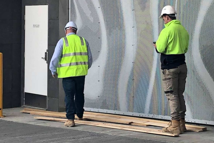 Hobart Myer boards on the ground with worker, January 2019.