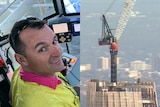 A man in a very high crane.