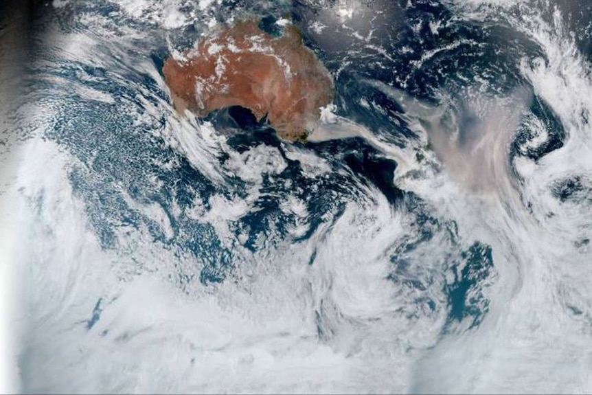 A satellite image showing brown smoke from bushfires spreading from the east coast of Australia towards and over New Zealand.