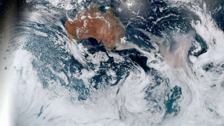 A satellite image showing brown smoke from bushfires spreading from the east coast of Australia towards and over New Zealand.