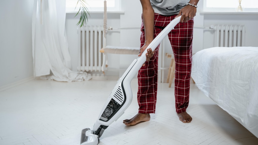 Man in Gray T-shirt Using Vacuum Cleaner