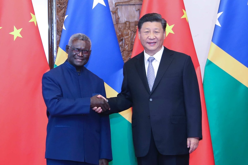 Solomon Islands' Prime Minister Manasseh Sogavare shaking hands with Chinese President Xi Jinping