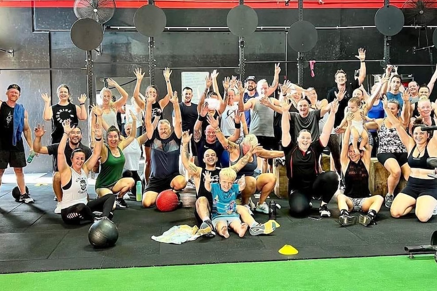 group of people smiling waving hands