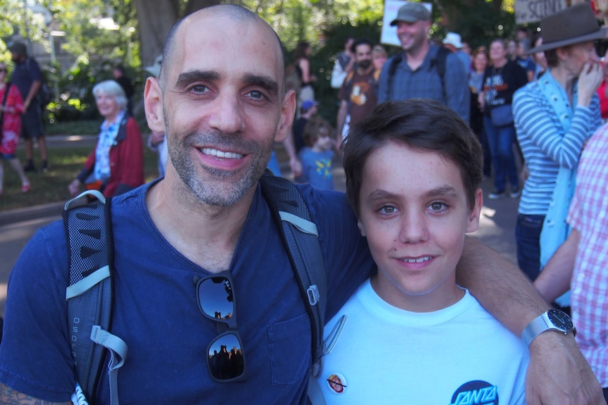 Gideon and his son pose for a photograph at the science march, Sydney, April 22, 2017.