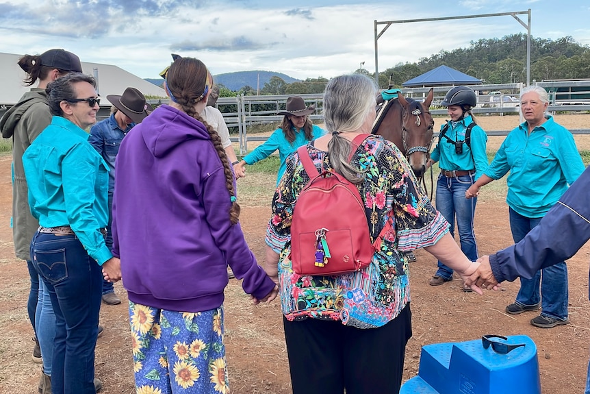 A circle of people holding hands