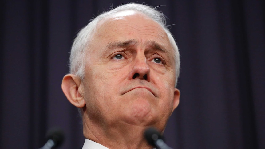 A close-up of Malcolm Turnbull's face shows frown lines on his forehead and around his mouth.