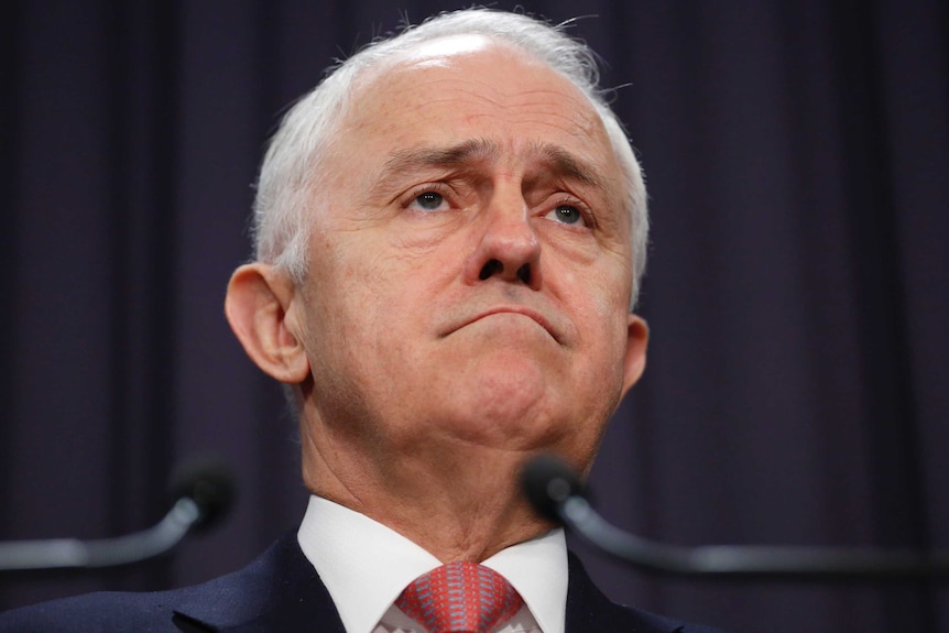 A close-up of Malcolm Turnbull's face shows frown lines on his forehead and around his mouth.