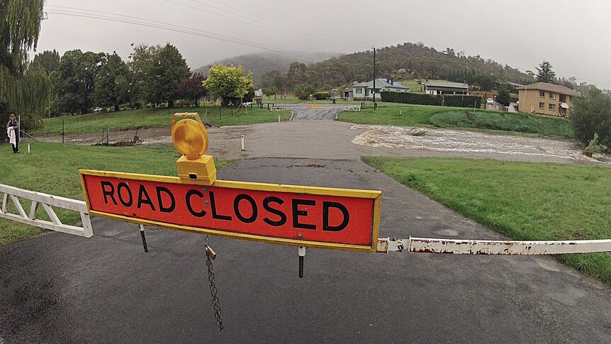 A road is closed due to the floodwaters flowing through the town of Cooma on March 1, 2012.