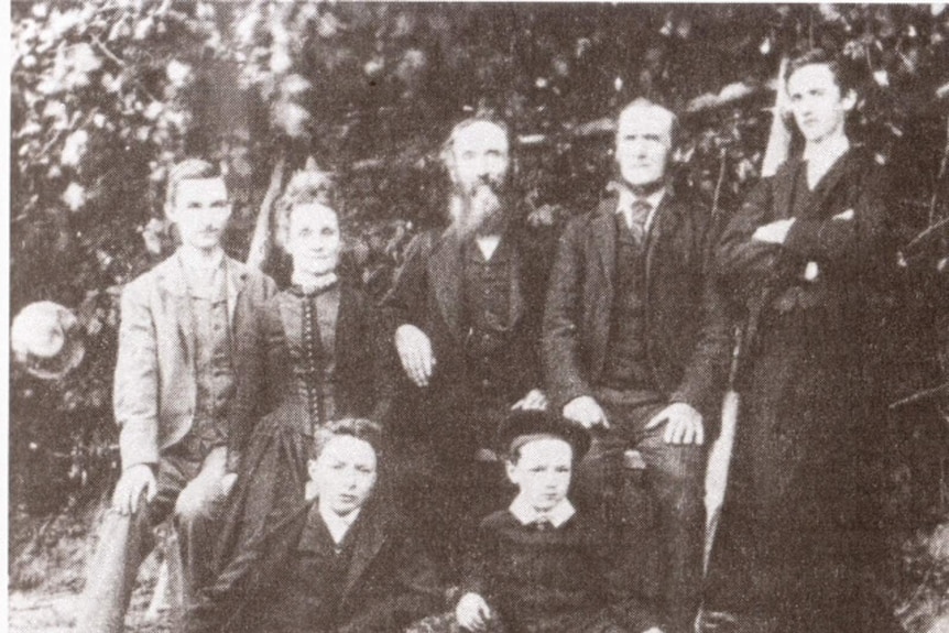 Grainy black and white photograph from the 1890s of an older man and woman with their four sons
