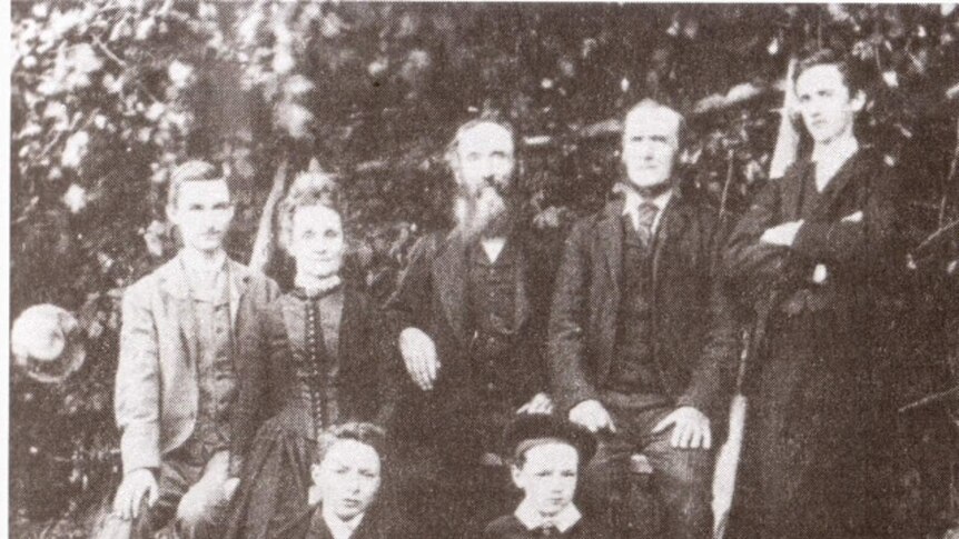Grainy black and white photograph from the 1890s of an older man and woman with their four sons
