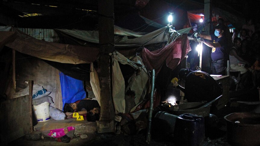 Crime scene investigators search for evidence during a shooting incident at the Market 3 Fishport in Navotas.