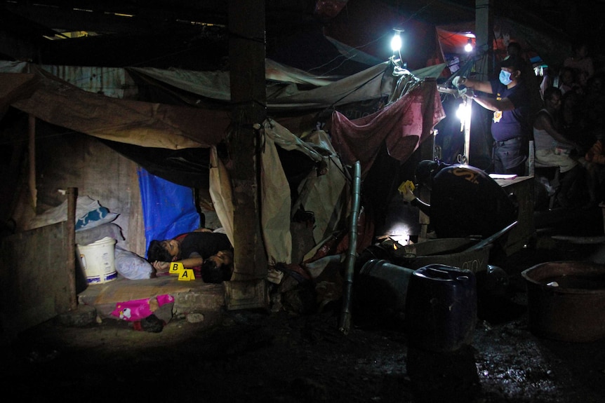 Crime scene investigators search for evidence during a shooting incident at the Market 3 Fishport in Navotas.