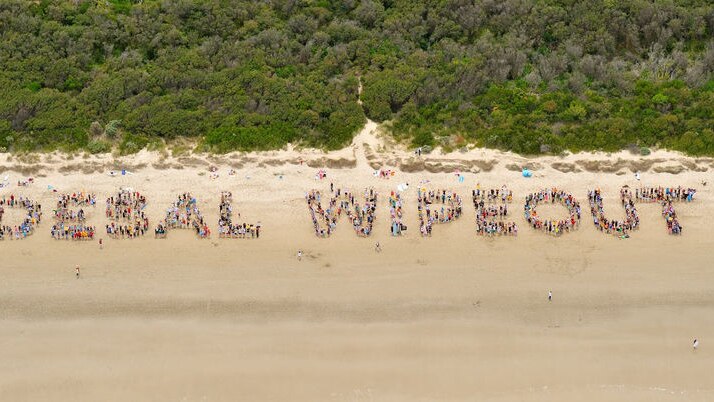 Anti-desal protestors took to the beach to spell out their protest.