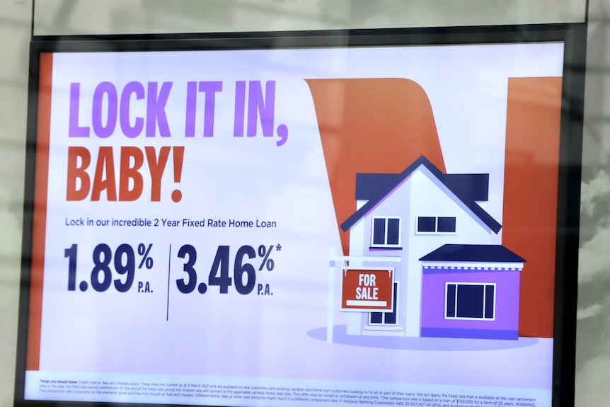 A bank poster says "lock it in baby" advertising a 1.89pc fixed interest rate.