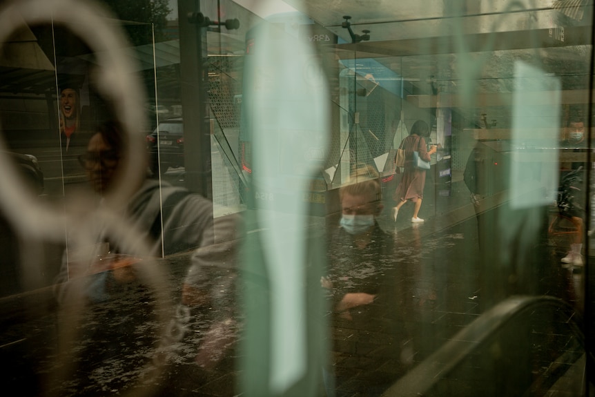 A shot of people walking with a reflection