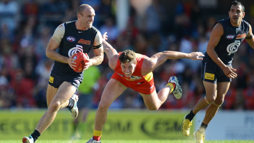 Chris Judd with the ball for Carlton against Gold Coast in round 18, 2013.