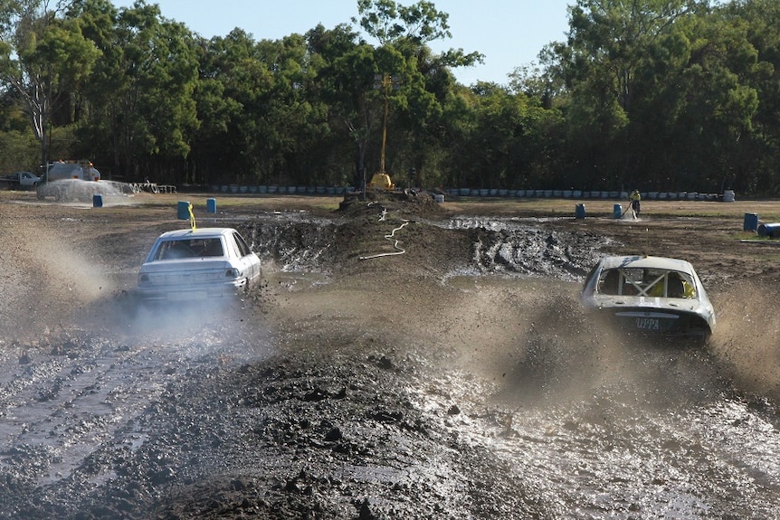 a car races through mud