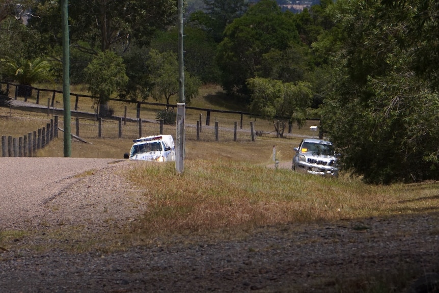 A police car and a damaged four-wheel drive on the side of a road new Newcastle