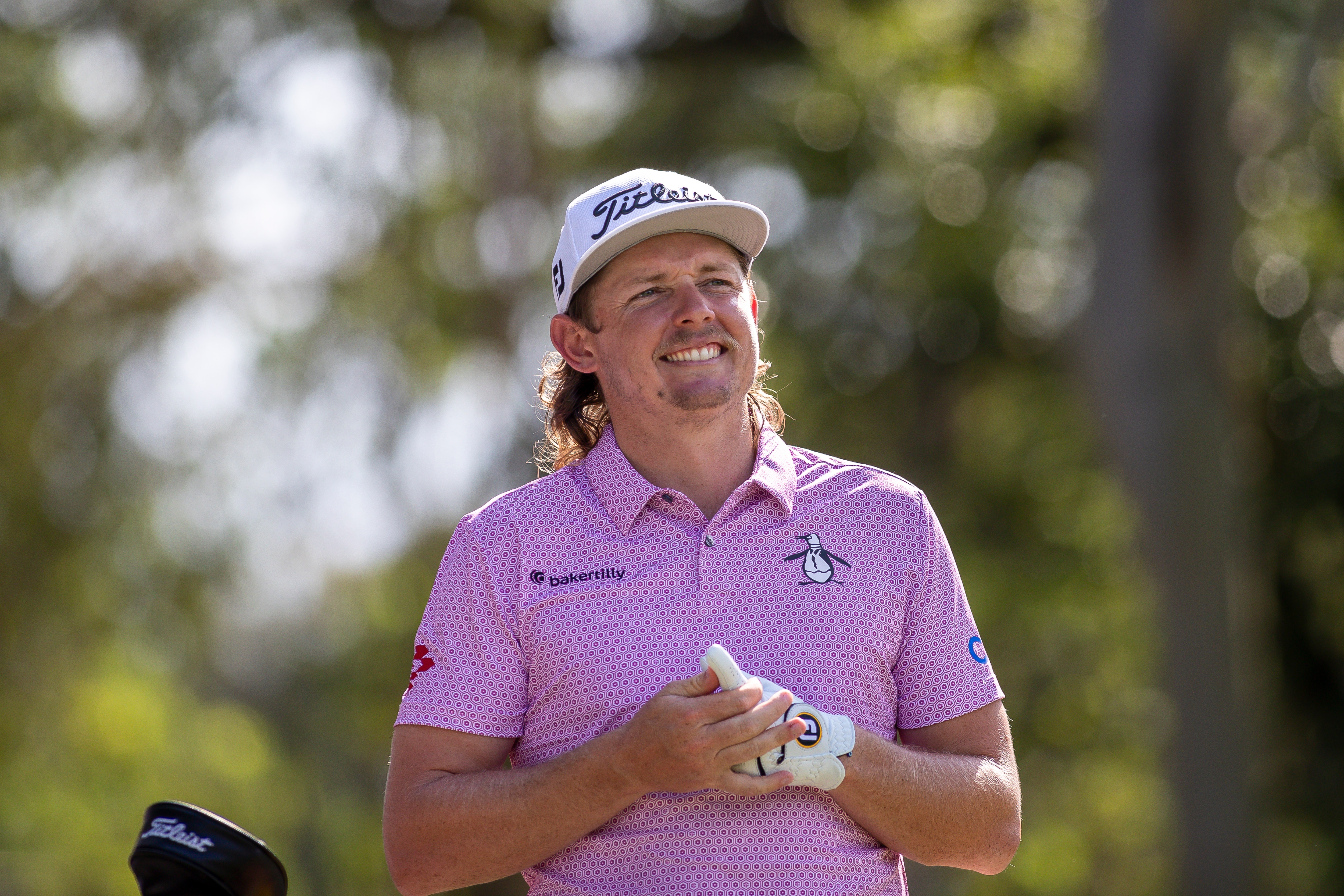 Australian golfer Cam Smith smiles as he looks down the fairway during the final round of a tournament.