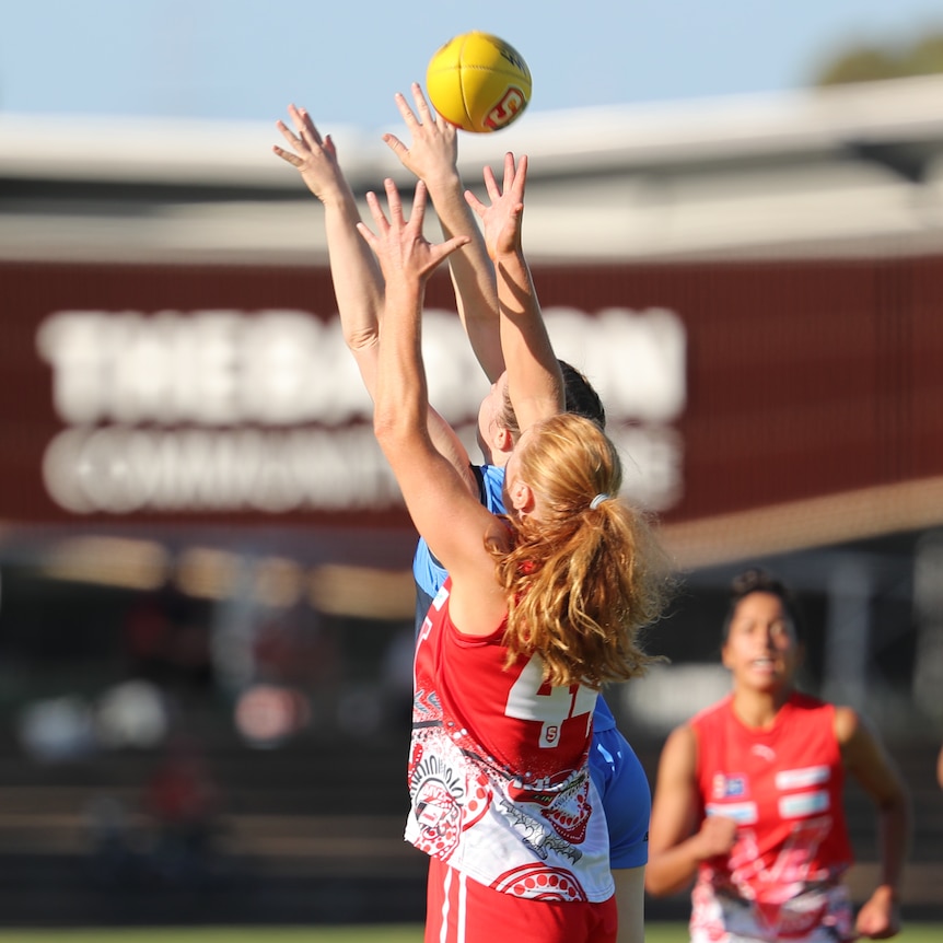 North Adelaide SANFLW player Meg Ryan leaps for a mark in a match against Sturt.