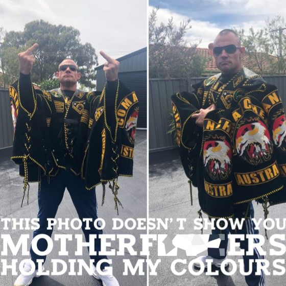 A photo of a large man wearing Comanchero colours with the text: This photo doesn't show you motherf***ers holding my colours.