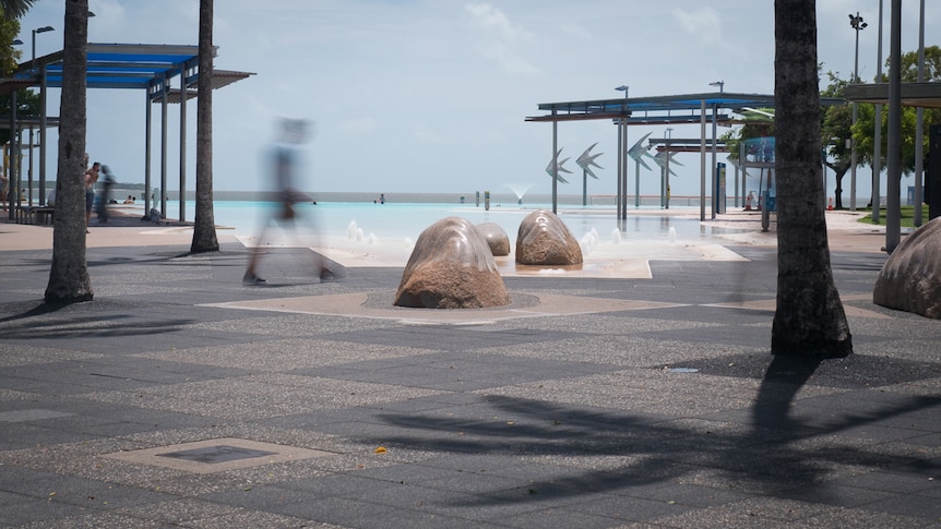 A man walks near a marina