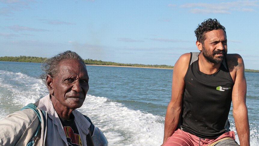Cecil Walmbeng and Bruce Martin in a boat in waters near Aurukun in Far North Queensland.