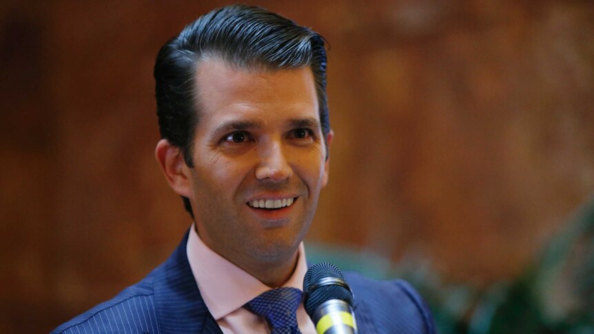 Donald Trump Jr flashes a coy smile at a press conference announcing the launch of a new hotel chain