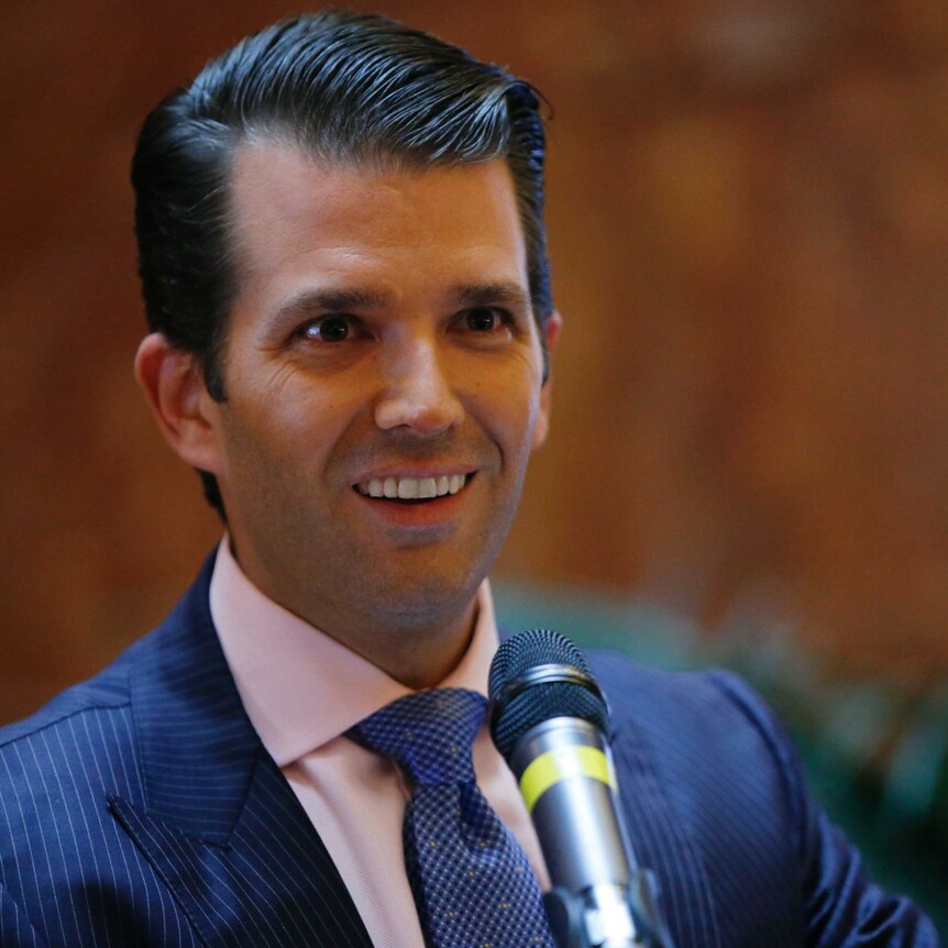 Donald Trump Jr flashes a coy smile at a press conference announcing the launch of a new hotel chain