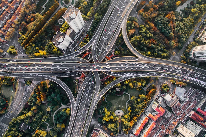 Bird's eye view of traffic across multiple motorways in Shanghai, China.