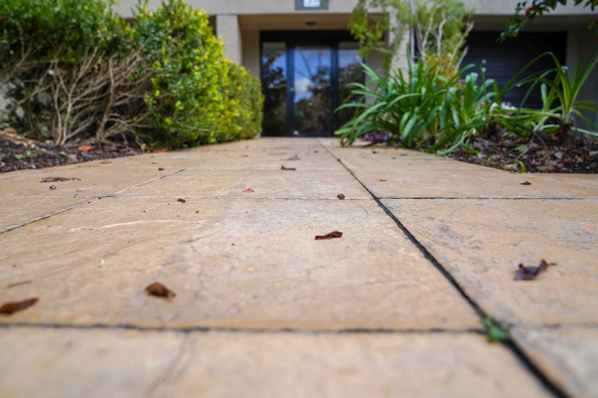 A paved path leading up to the entrance to an apartment building in Sydney.