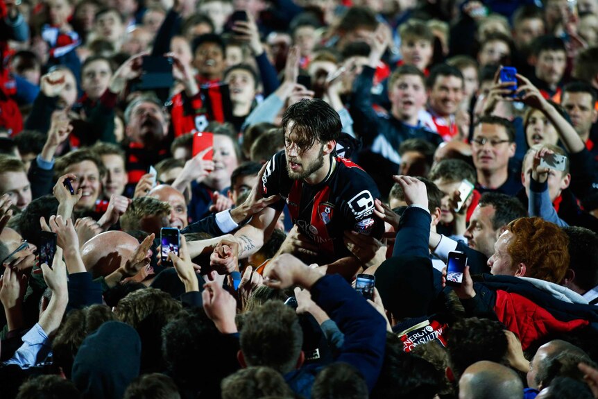 Harry Arter celebrates with fans after Bournemouth promotion