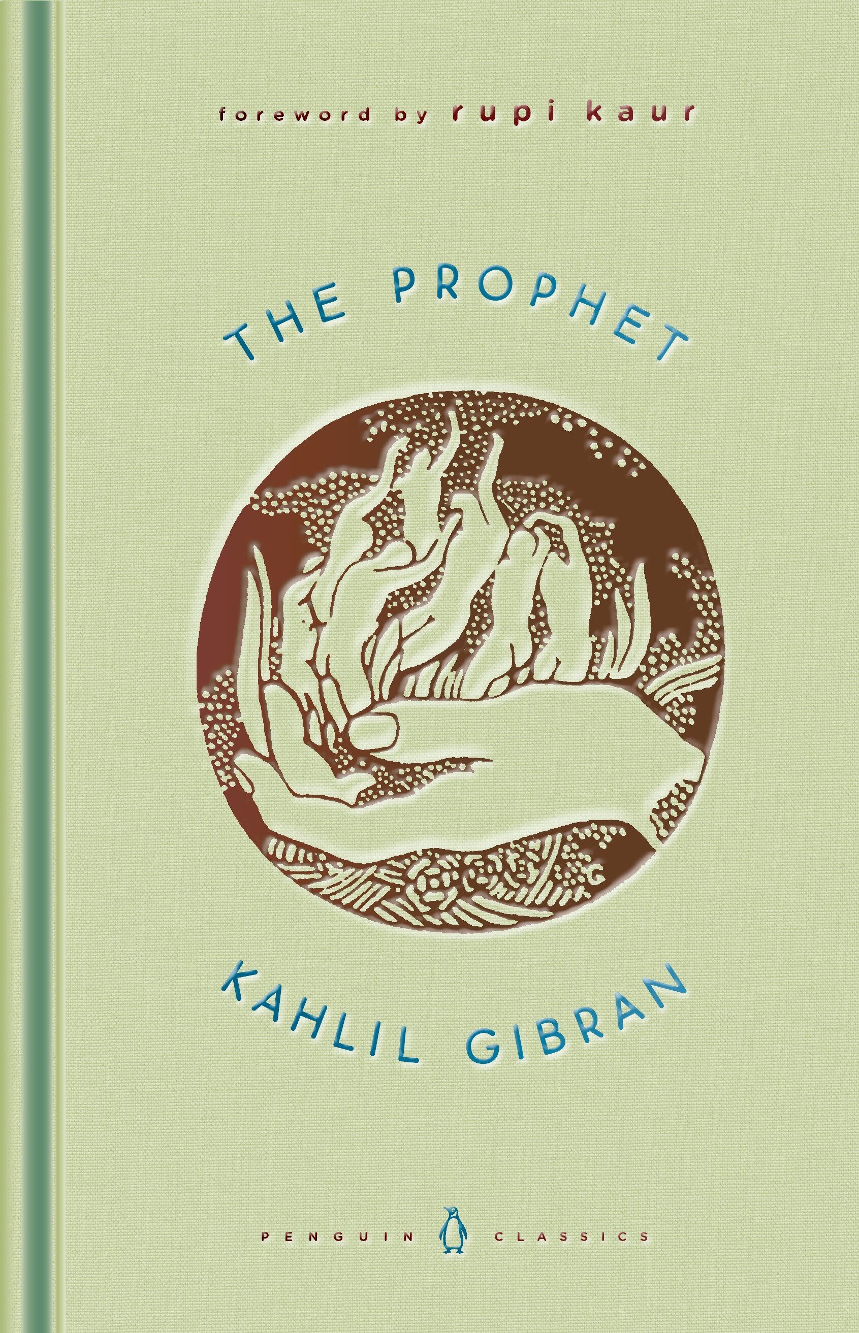 The cover of The Prophet by Kahlil Gibran features an illustration of several people dancing in the palm of a hand.