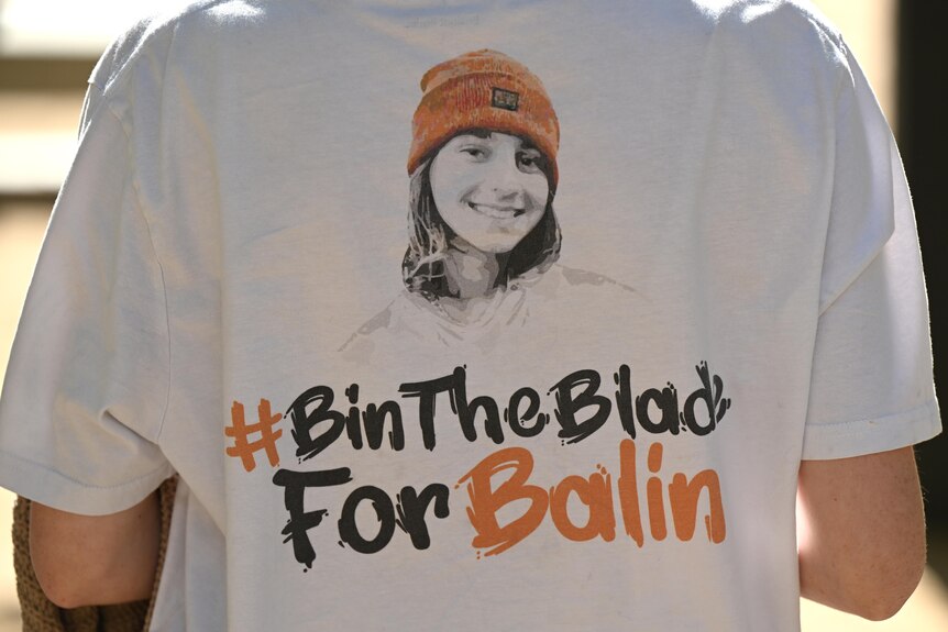 a close-up of someone wearing a t shirt that says 'bin the blade for balin' in honour of a teenage manslaughter victim