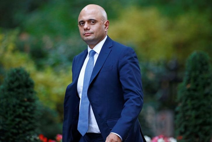 British secretary of state Sajid Javid looks to the camera with a stern expression as he arrives at 10 Downing Street